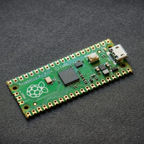 Microcontroller board with Raspberry Pi logo and USB port.